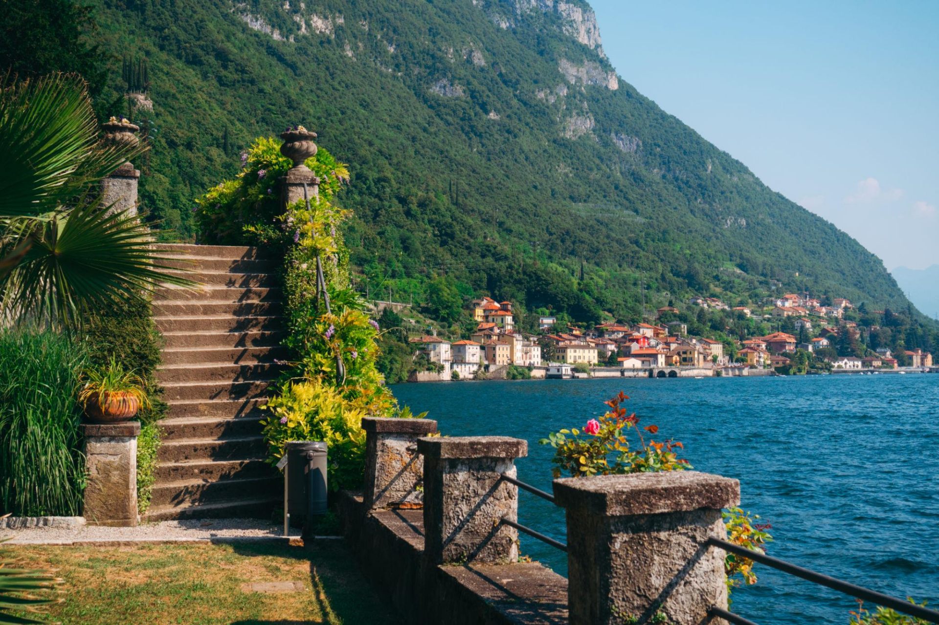 Stone stairway by Lake Como with mountain backdrop