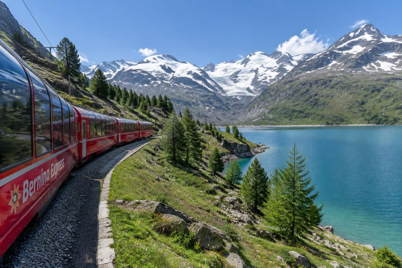 Red Bernina line train beside an Engadin lake