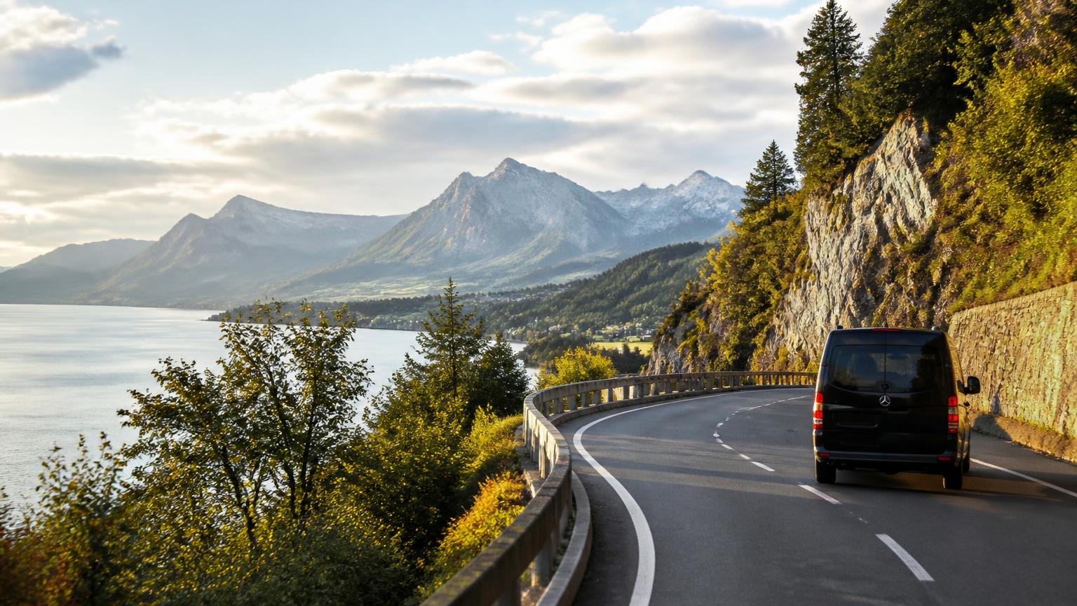 Scenic alpine road beside Lake Constance with a black Mercedes van on a European road trip