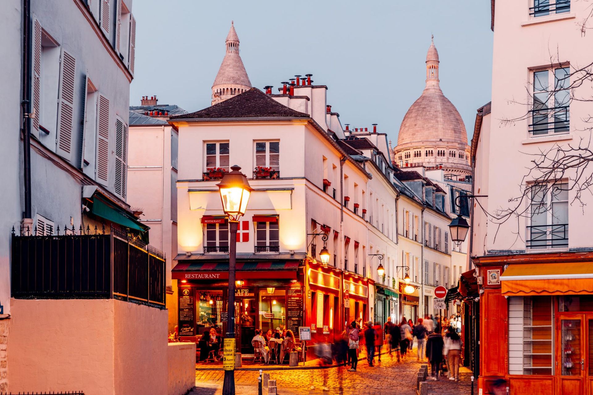 Montmartre street with Sacré-Cœur at dusk