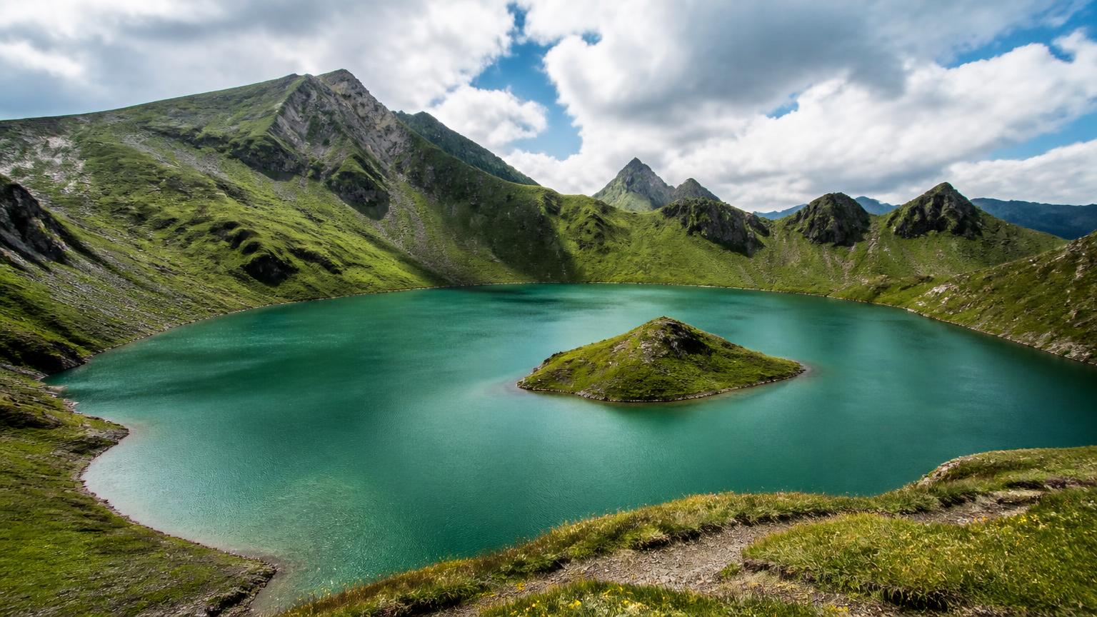 Turquoise Schrecksee mountain lake with its small island in the Allgäu Alps, Germany