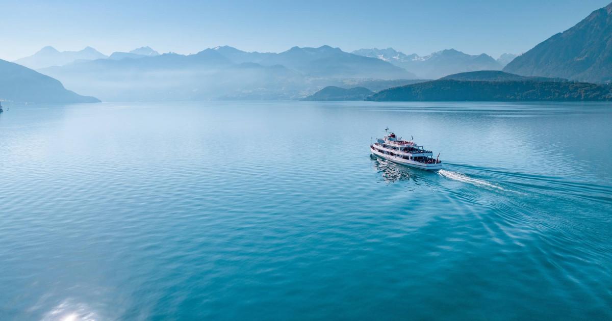 Boat cruising on a calm Swiss alpine lake