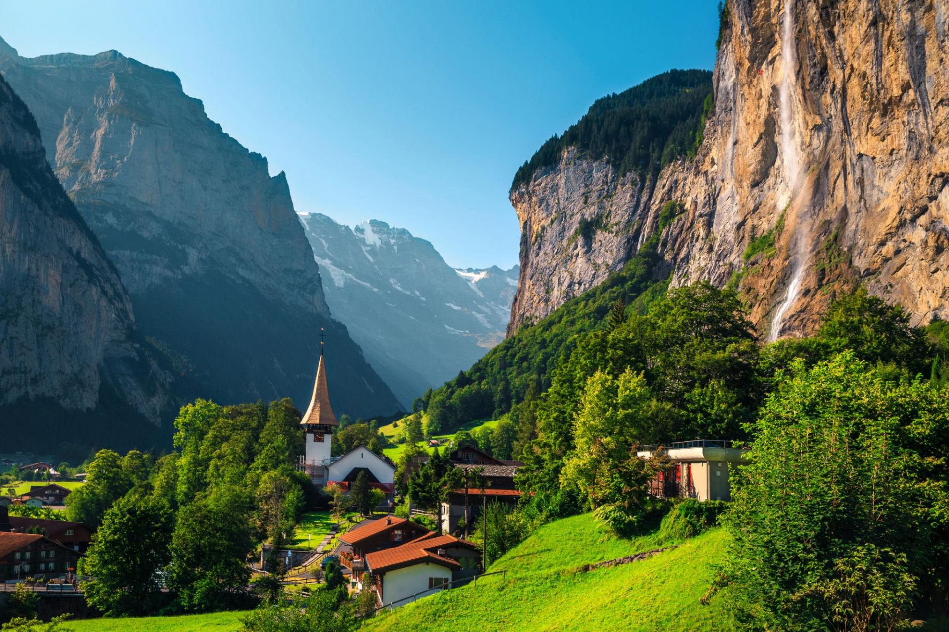 Lauterbrunnen valley with waterfall and Swiss Alps