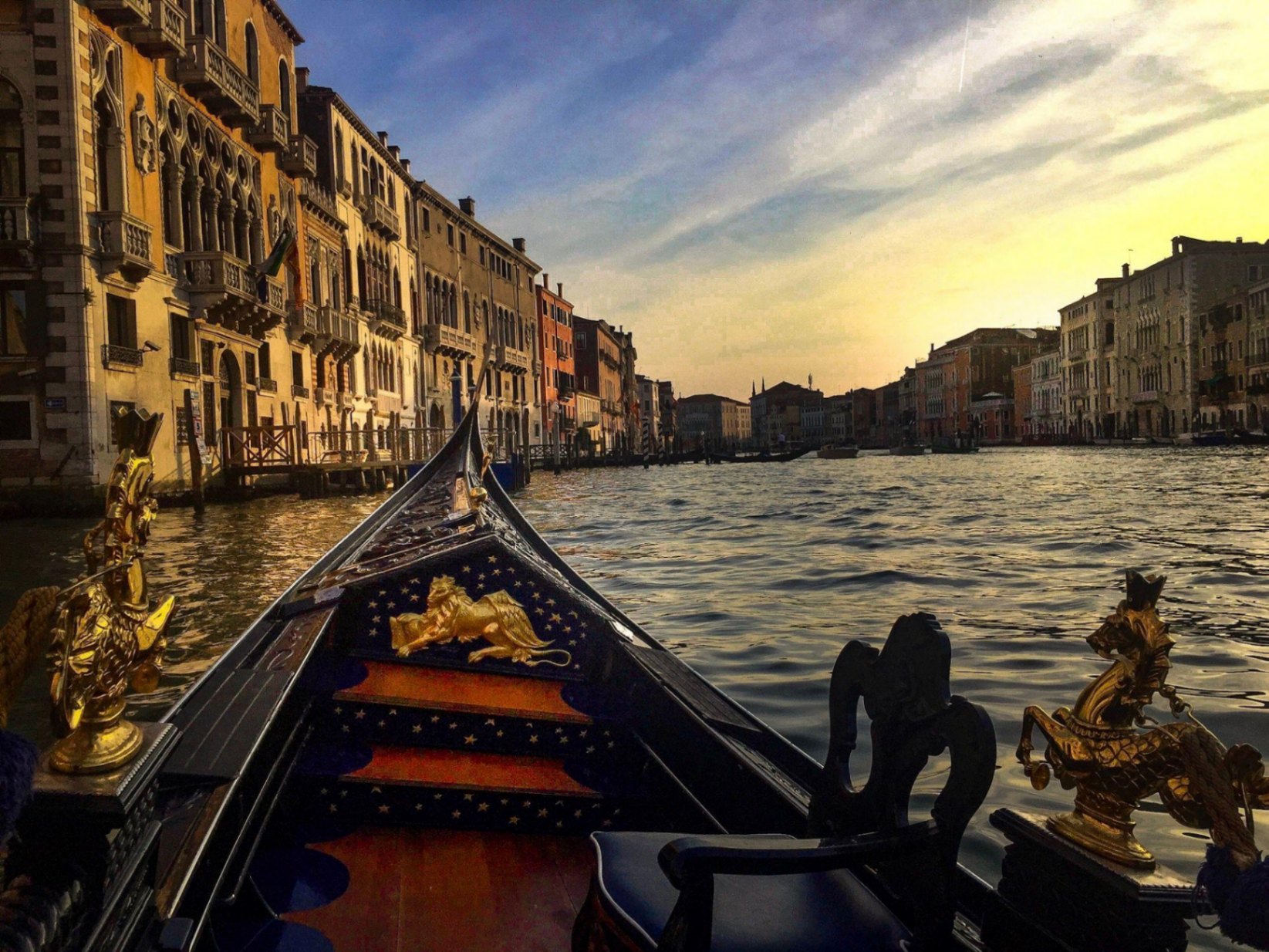 Gondola gliding down the Grand Canal at sunset